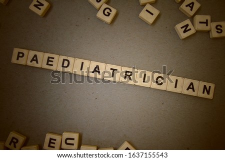 Paediatrician, word cube with background.