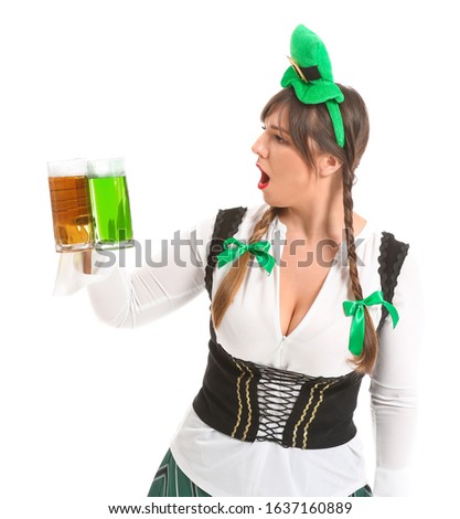 Funny young woman with beer on white background. St. Patrick's Day celebration