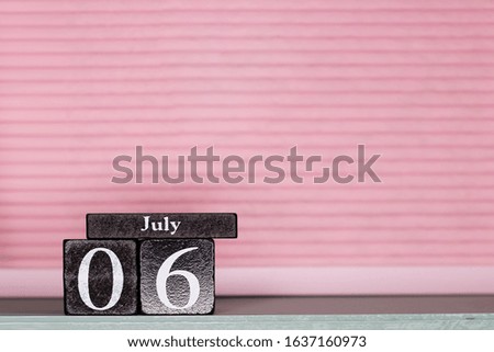 July 6, day 6 of month, calendar on a wooden cubes