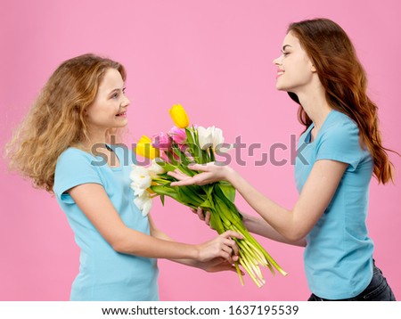 Merry mom and daughter flowers as a gift of joy pink background