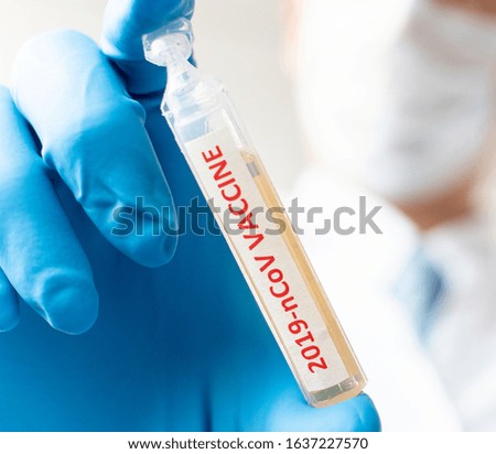 Medical doctor or laborant holding tube with nCoV Coronavirus vaccine for 2019-nCoV virus. Novel Coronavirus originating in Wuhan, China. Coronavirus 2019-nCoV concept.