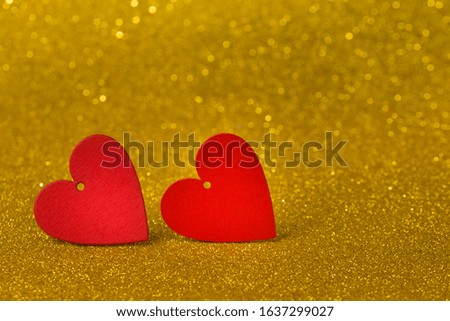 Valentines day concept with hearts. red hearts on golden glitter background