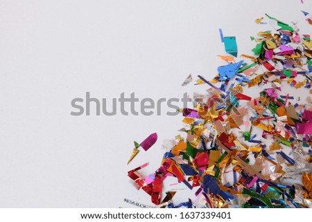 Color confetti paper on a white background carnival. Abstract frame
