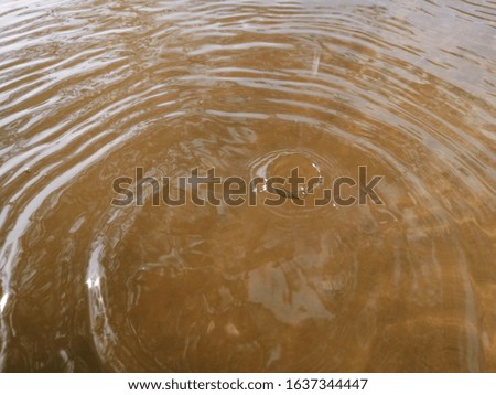 The  metal​ texture​ of surface​ blue​ water​ reflected​ with​ sunlight​ for​ background. Abstract​ of reflection​ on surface​ natural​ water for​ background​