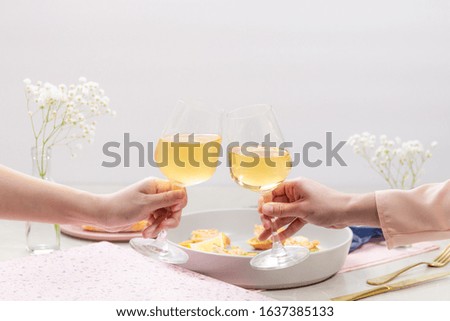 Couple having clinking glasses with tasty wine romantic dinner.