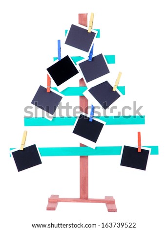 Wooden hand made fir tree with empty photo paper, isolated on white