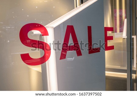 'Sale' sign on glass shop window
