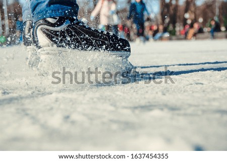 Legs of skater on ice rink