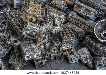 Stack of aluminium alloy cylinder head for recycling. 
 Scrap engines parts for recycling.