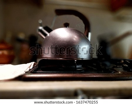 classic silver kettle on a gas stove