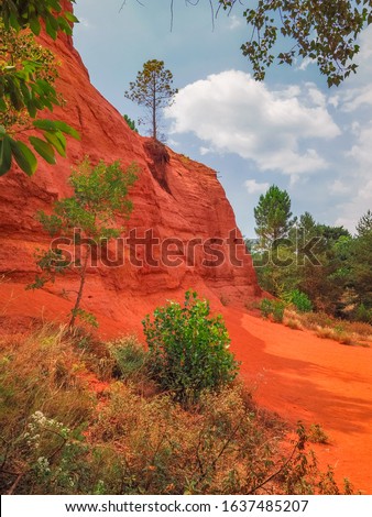 Provence Colorado valley in Luberon Natural park, Rustrel, France. Spectacular, colorful desert scenery, orange red rock formations in former ocher-mining quarries. Magical view. Beautiful landscape.