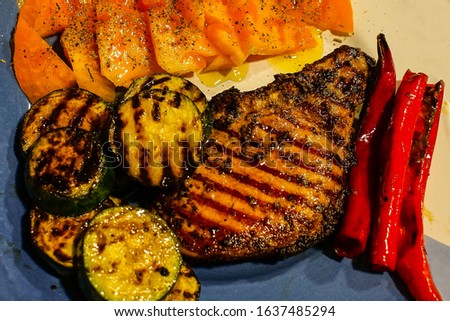 juicy bright grilled steak with vegetables, red pepper and grilled zucchini