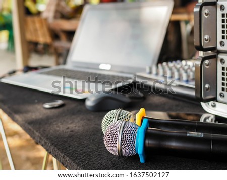 2 microphones placed on the table, the black floor in front of the audio set.
