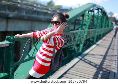 Young woman laughing joyful on bridge / Mae Hong Son Province of thailand