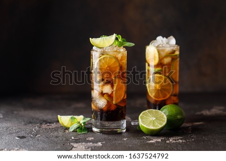 Cuba Libre with brown rum, cola, mint and lime. Cuba Libre or long island iced tea cocktail with strong drinks Royalty-Free Stock Photo #1637524792