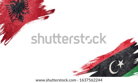 Flags of Albania and Libya on white background
