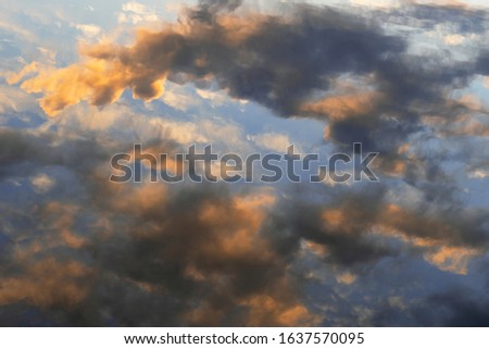 Evening sky reflected in water. Reflection of the sky in the water at sunset as an abstract background