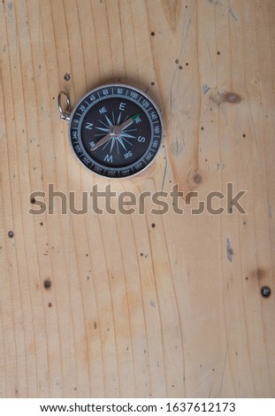 Compass on old wooden table