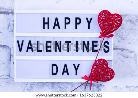 Happy Valentine's Day lightbox message with red decorative heart.  Love concept.  Flat lay