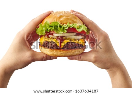 Hands holding hamburger on white