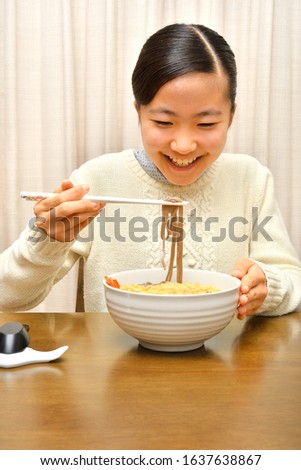 Japanese girl enjoys having buckwheat noodle with deep fried shrimp