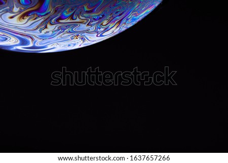 Soap bubble. Abstract background. Space model. Streaks of fluid. Surface with psychedelic colors. Virtual reality planet. Free space for an inscription. Conceptual image of the universe.
