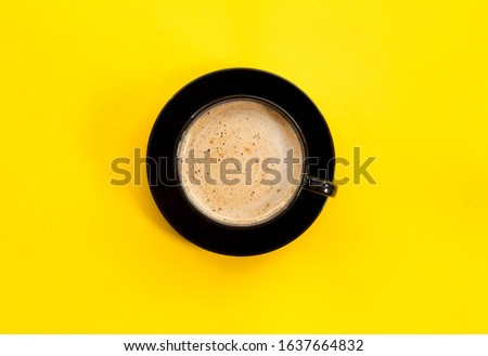 Top view image of coffe cup on yellow background. Flat lay. Copy space