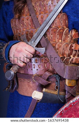 People in Middle ages, vintage viking and knight costumes. Ancient leather armor - 
leather detail.