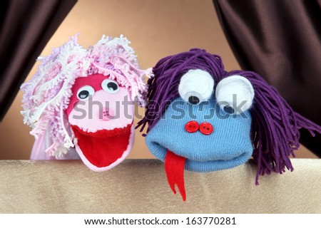 Puppet show on brown background Royalty-Free Stock Photo #163770281