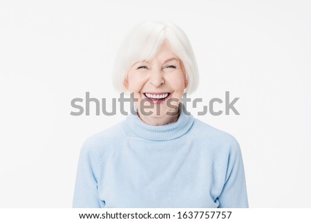 Attractive old woman with pretty smiling face on white background