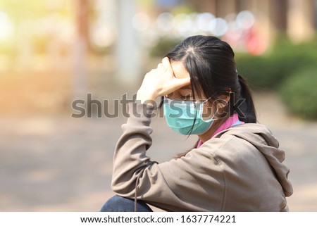 Girl has a mask to protect herself from Corona virus, woman get sick from Corona Virus, panic or stress from work or coronavirus, traveler with a mask on nose for her safety outdoor activity, illness Royalty-Free Stock Photo #1637774221