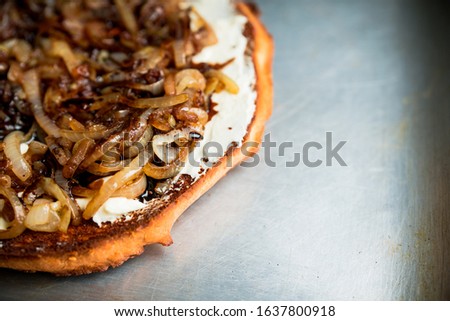 Homemade pizza with goat cheese, caramelized onion and balsamic vinegar. Selective focus. Shallow depth of field.