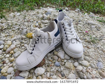 a couple white shoes on stones. photo taken on home yard