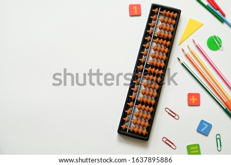 Mental arithmetic and Mathematics concept: colorful pens and pencils, numbers, abacus scores on white background, copy space Royalty-Free Stock Photo #1637895886