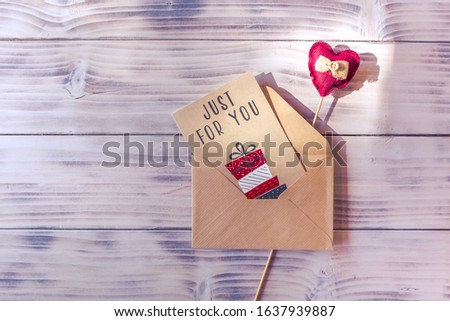 Red textile heart on a wooden stick and just for you letter card. Background. Valentines day