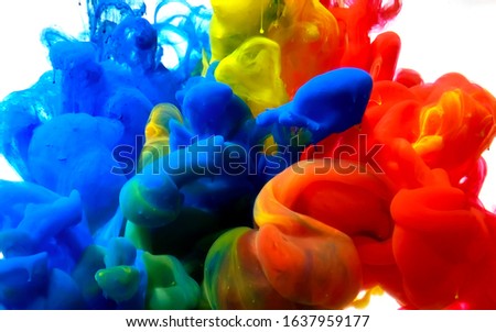 Blue, yellow and red watercolor ink in water. Stylish abstract modern background. A powerful explosion of colors. Cool trending screensaver.