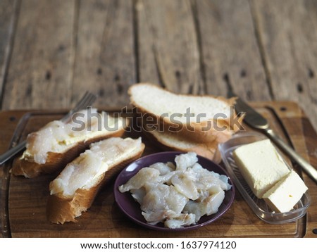 Breakfast, lunch, snack. Sandwiches with butter and freshly salted fish pike on a cutting kitchen board. XE fish salad. Wooden ancient background. Royalty-Free Stock Photo #1637974120