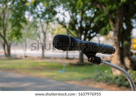 Outdoor microphone.One black microphone.A black microphone on the lawn and the road Royalty-Free Stock Photo #1637976955