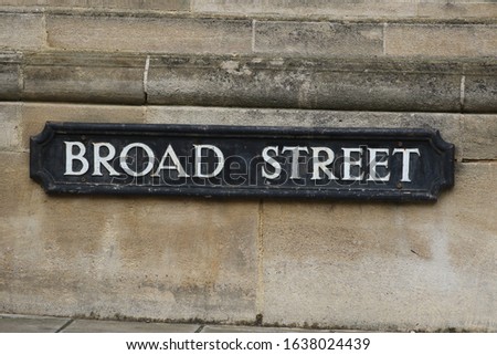 iron street sign, one of the older types of sign labelling Broad Street one of the main streets in the city centre of Oxford near the Sheldonian theatre and at a junction with Holywell Street Royalty-Free Stock Photo #1638024439