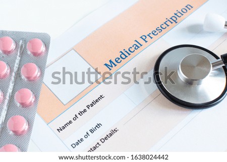 Medical prescription with doctor's sthetoscope and pills closeup.