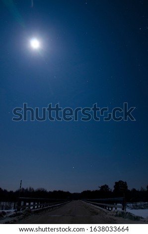 Beautiful moonlight in winter on the road