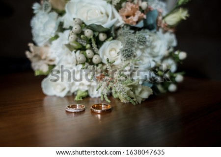 wedding rings with a bouquet of the bride and shoes