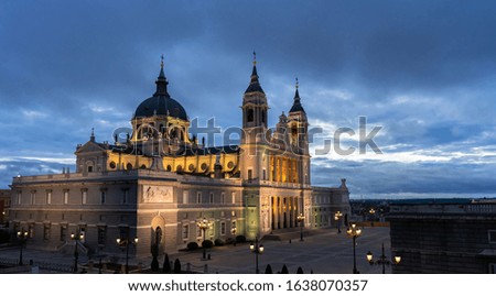 Night view of the Saint Mary the Royal of La Almudena Cathedral in Madrid on a cloudy day without people. Travel concept.
