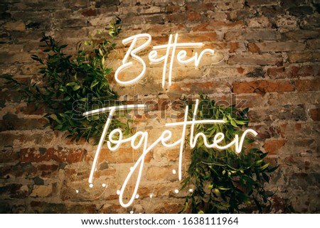 Better Together - neon sign on a brick wall in a restaurant at a wedding party. Love concept Royalty-Free Stock Photo #1638111964
