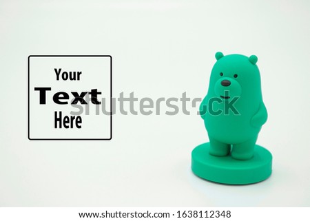 A green teddy bear figurine isolated in white background with copy space