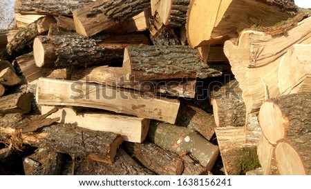 Natural background with lumber wood outdoor close up. Scenic macro view of fresh timber stock. Pattern of stacked woodpiles for heating old residential house in the countryside.