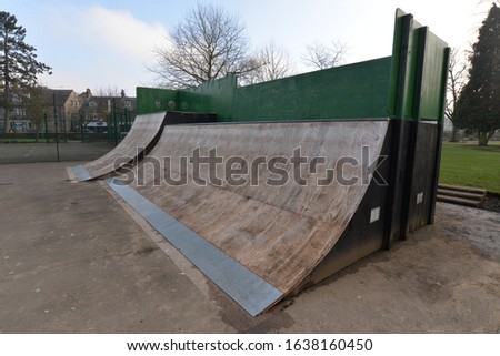 Public skate park with ramps and jumps for rollerblading and skateboarding recreational use