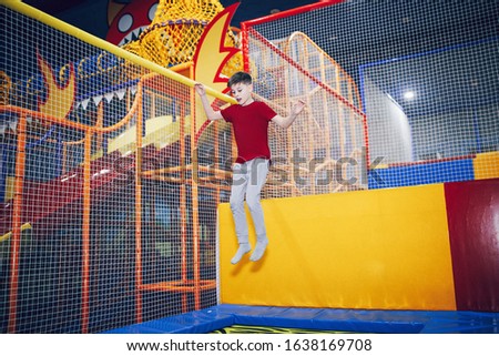 

Boy jumping on a trampoline in an entertainment center