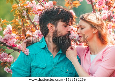 Kissing couple in spring nature close-up portrait. Easter couple, Couple in love enjoying pink cherry blossom