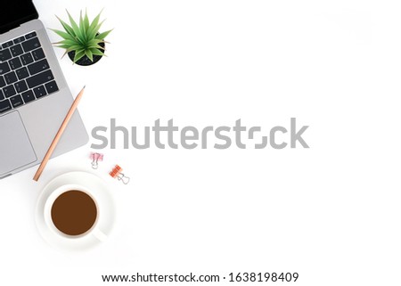 Flat lay office business concept on white table desk background with laptop computer and coffee cup, pencil and paper clip, green plant, Top view with copy space, work space